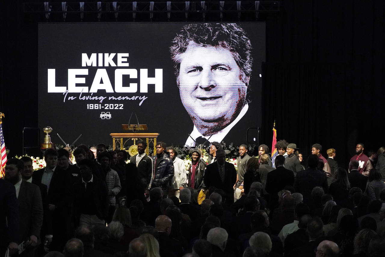 Current football players enter the memorial service for their late Mississippi State football coach...