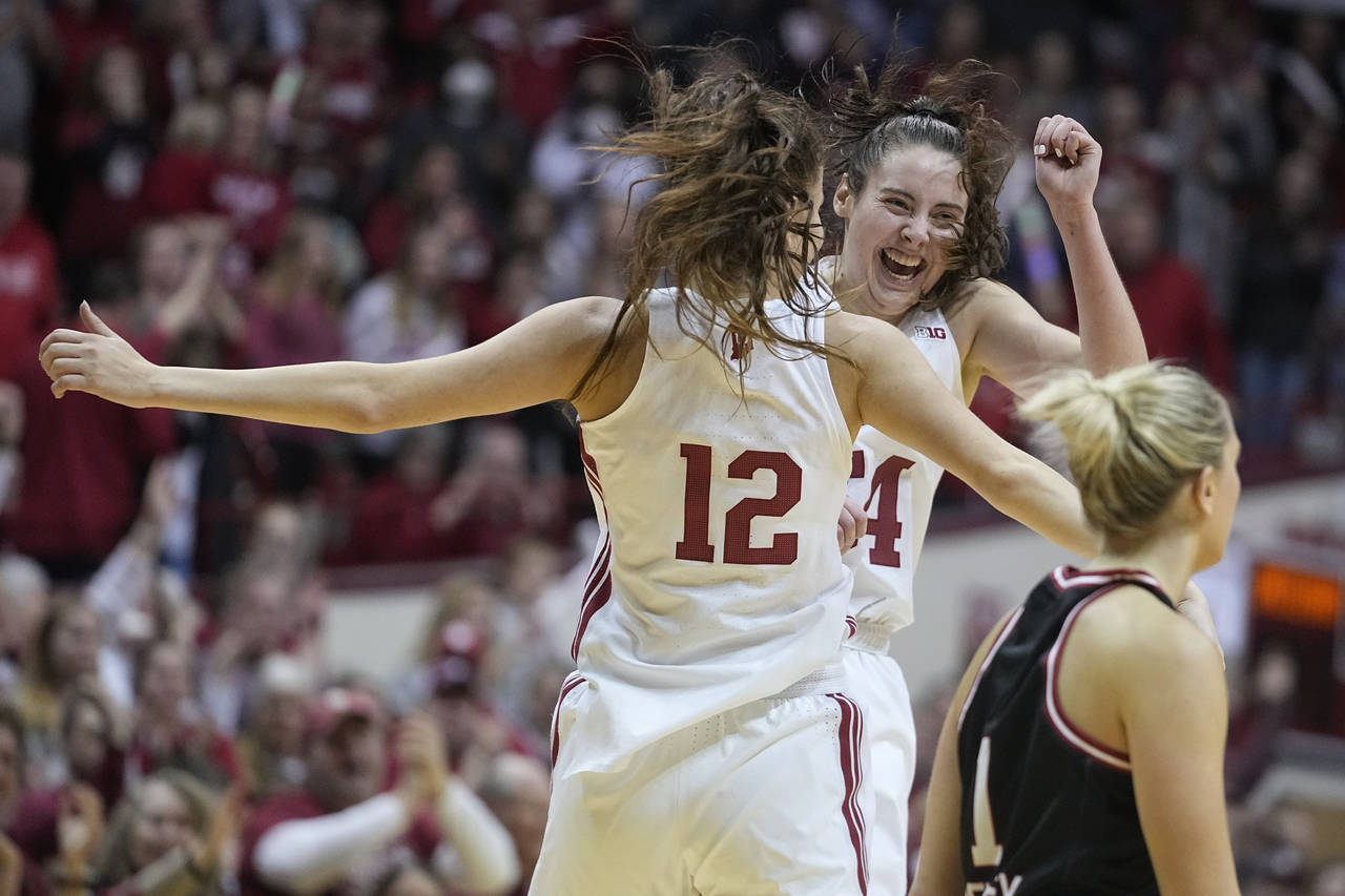 Indiana's Yarden Garzon (12) and Mackenzie Holmes celebrate as Nebraska's Jaz Shelley (1) walks pas...