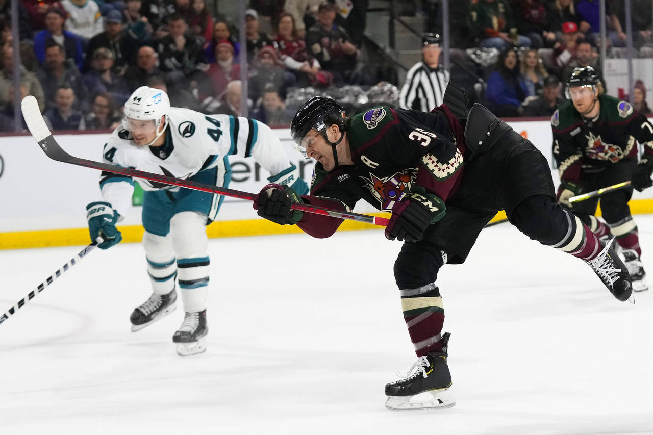 Arizona Coyotes right wing Christian Fischer, middle, watches his score as San Jose Sharks defensem...