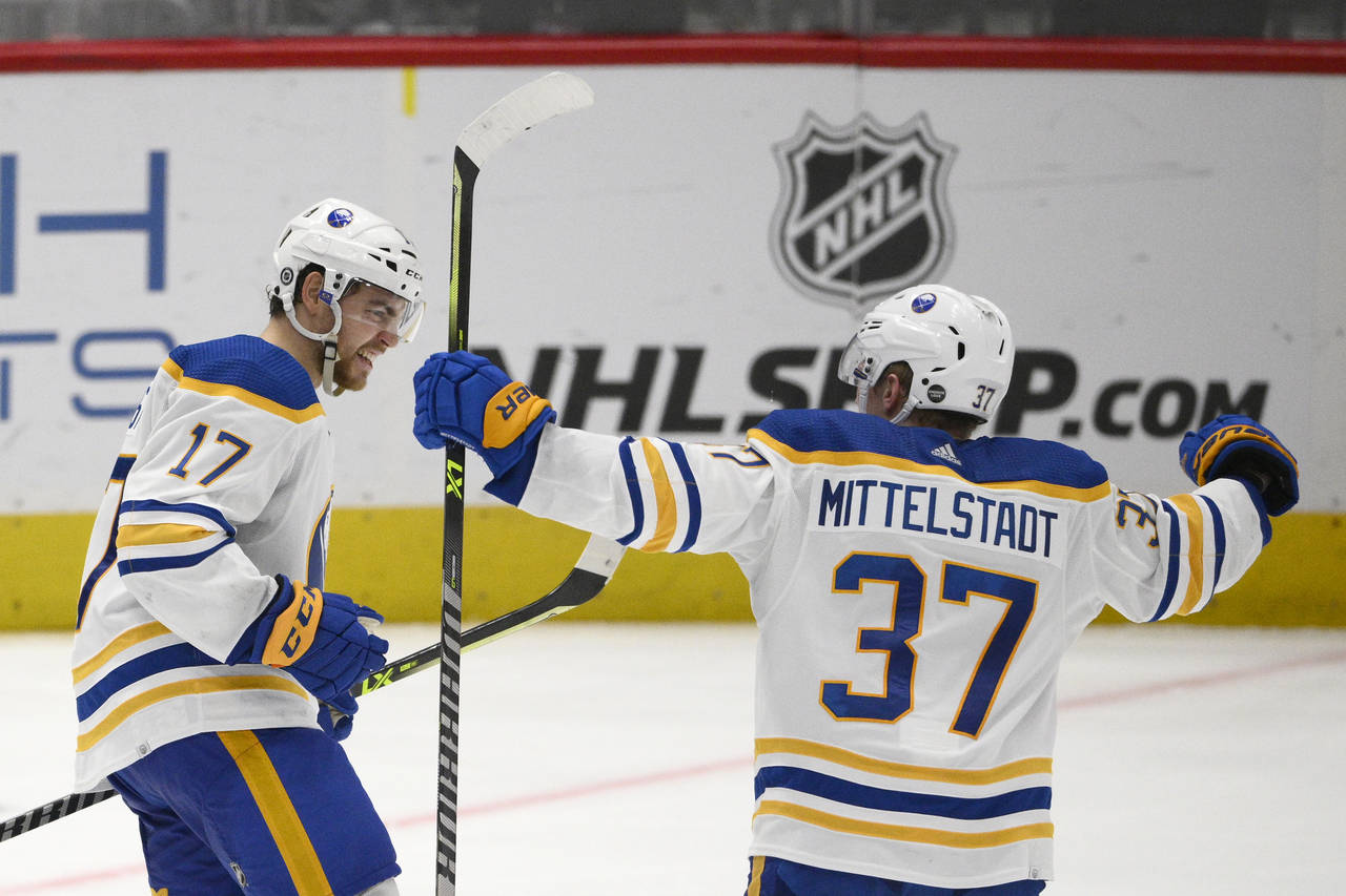 Buffalo Sabres center Tyson Jost (17) celebrates his goal with center Casey Mittelstadt (37) during...