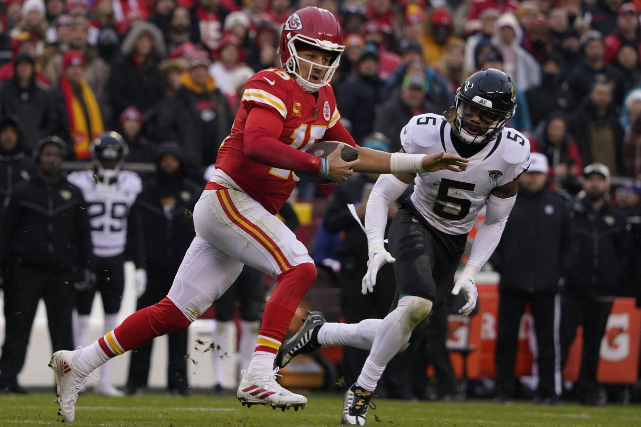 Kansas City Chiefs quarterback Patrick Mahomes (15) runs out of the pocket as Jacksonville Jaguars ...