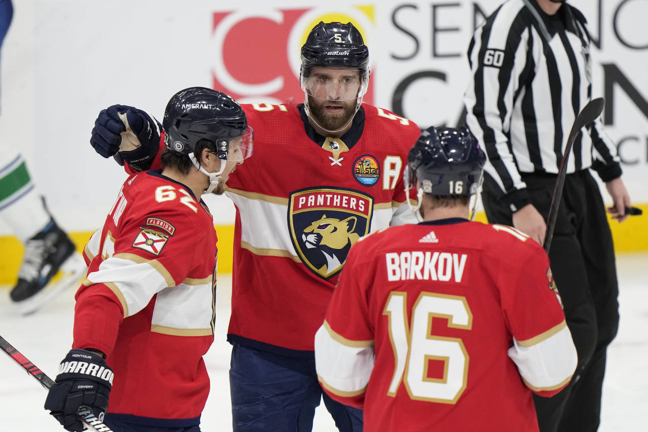 Florida Panthers defenseman Aaron Ekblad (5) celebrates after scoring with defenseman Brandon Monto...