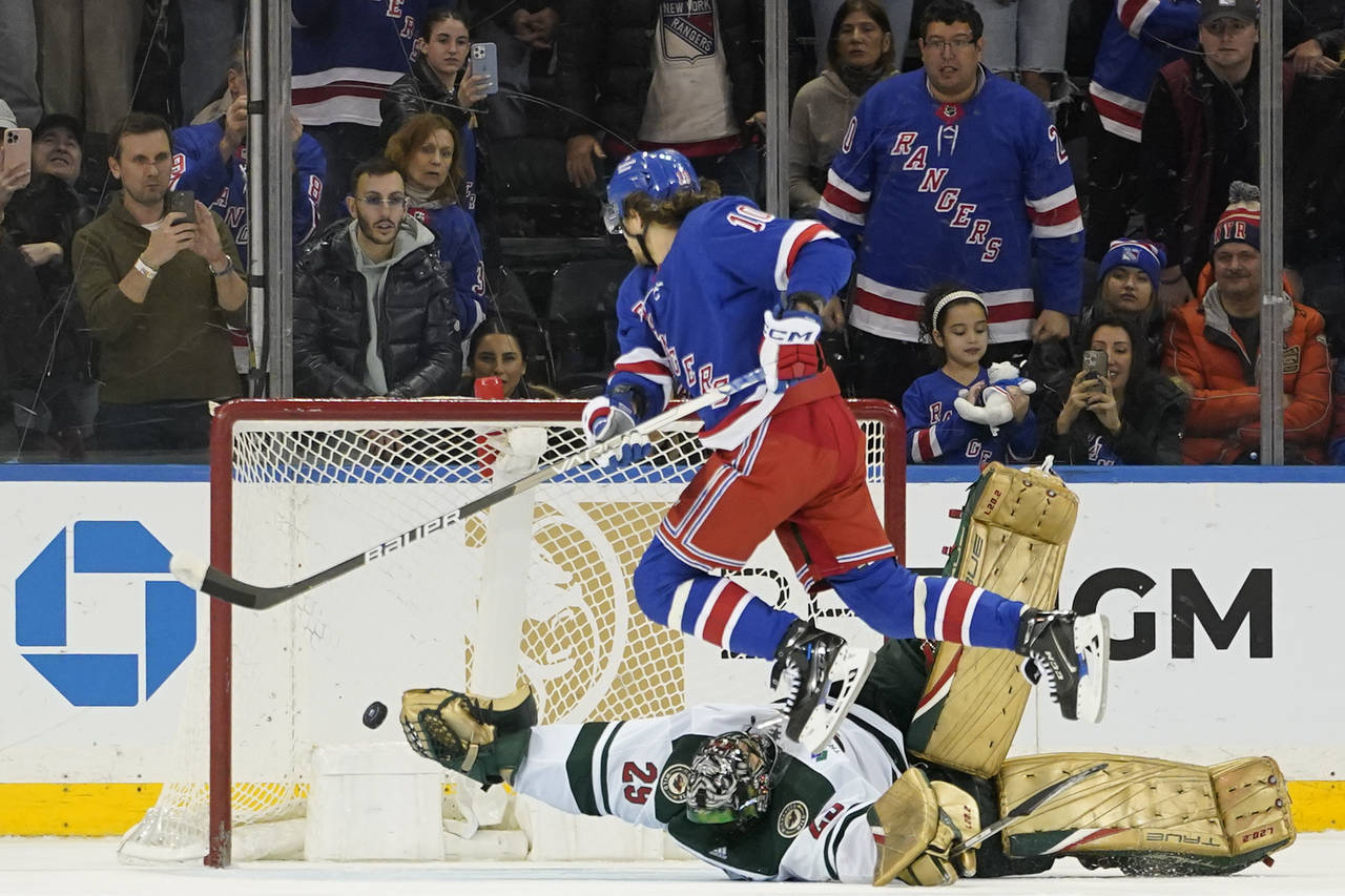 New York Rangers left wing Artemi Panarin (10) scores the winning goal against Minnesota Wild goalt...