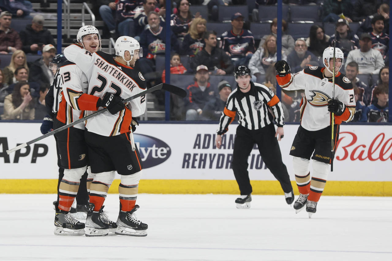 Anaheim Ducks' Simon Benoit, left, celebrates his goal against the Columbus Blue Jackets with Kevin...