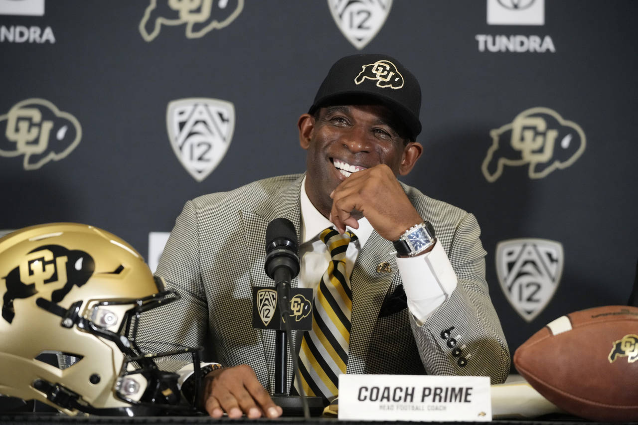 FILE - Deion Sanders speaks after being introduced as the new head football coach at the University...