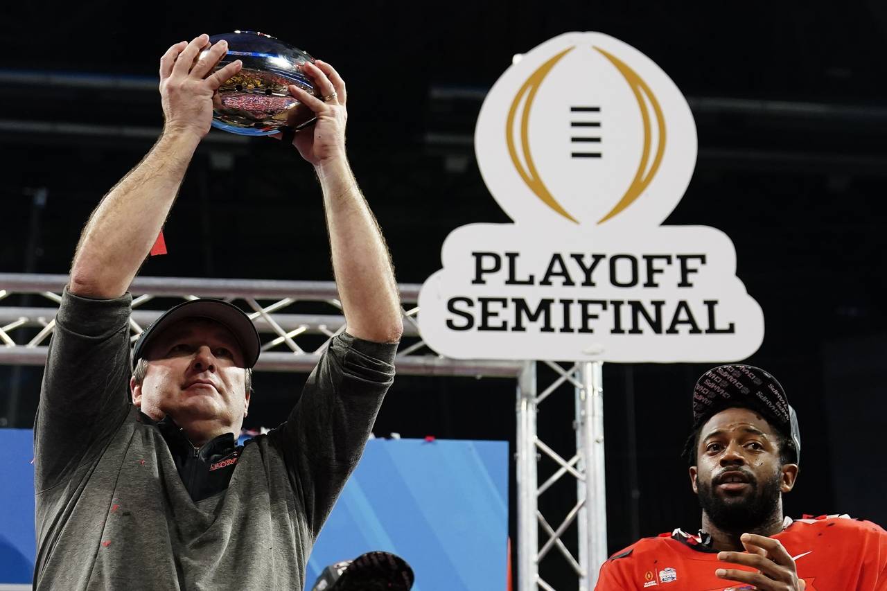 Georgia head coach Kirby Smart holds the The George P. Crumbley Trophy after the Peach Bowl NCAA co...