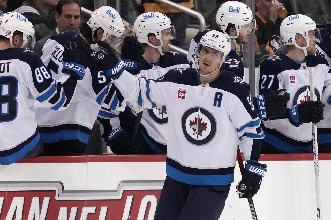 Winnipeg Jets' Mark Scheifele (55) returns to the bench after scoring against the Pittsburgh Pengui...