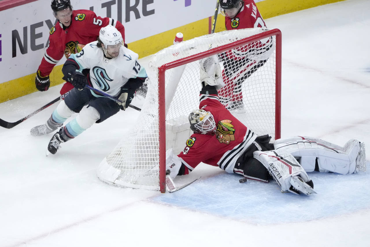 Chicago Blackhawks goaltender Alex Stalock, right, makes a save as Seattle Kraken's Brandon Tanev (...