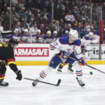 Oilers beat reeling Canucks 4-2 for 6th straight victory.