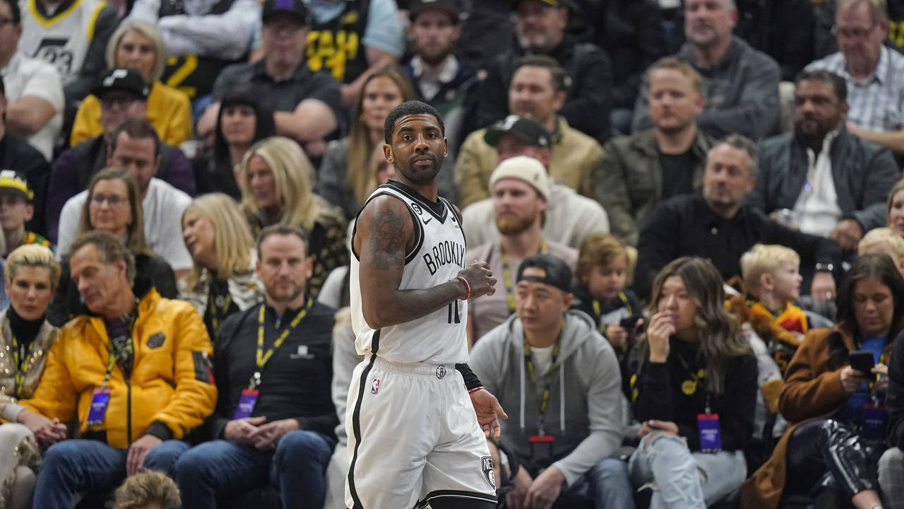 Brooklyn Nets guard Kyrie Irving (11) looks on during the first half of an NBA basketball game agai...