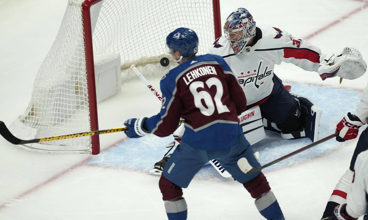 Colorado Avalanche left wing Artturi Lehkonen, front, looks on as his shot sails past Washington Ca...