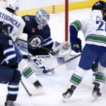 Connor's hat trick powers Jets' 7-4 win over Canucks