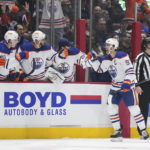 Oilers beat reeling Canucks 4-2 for 6th straight victory.