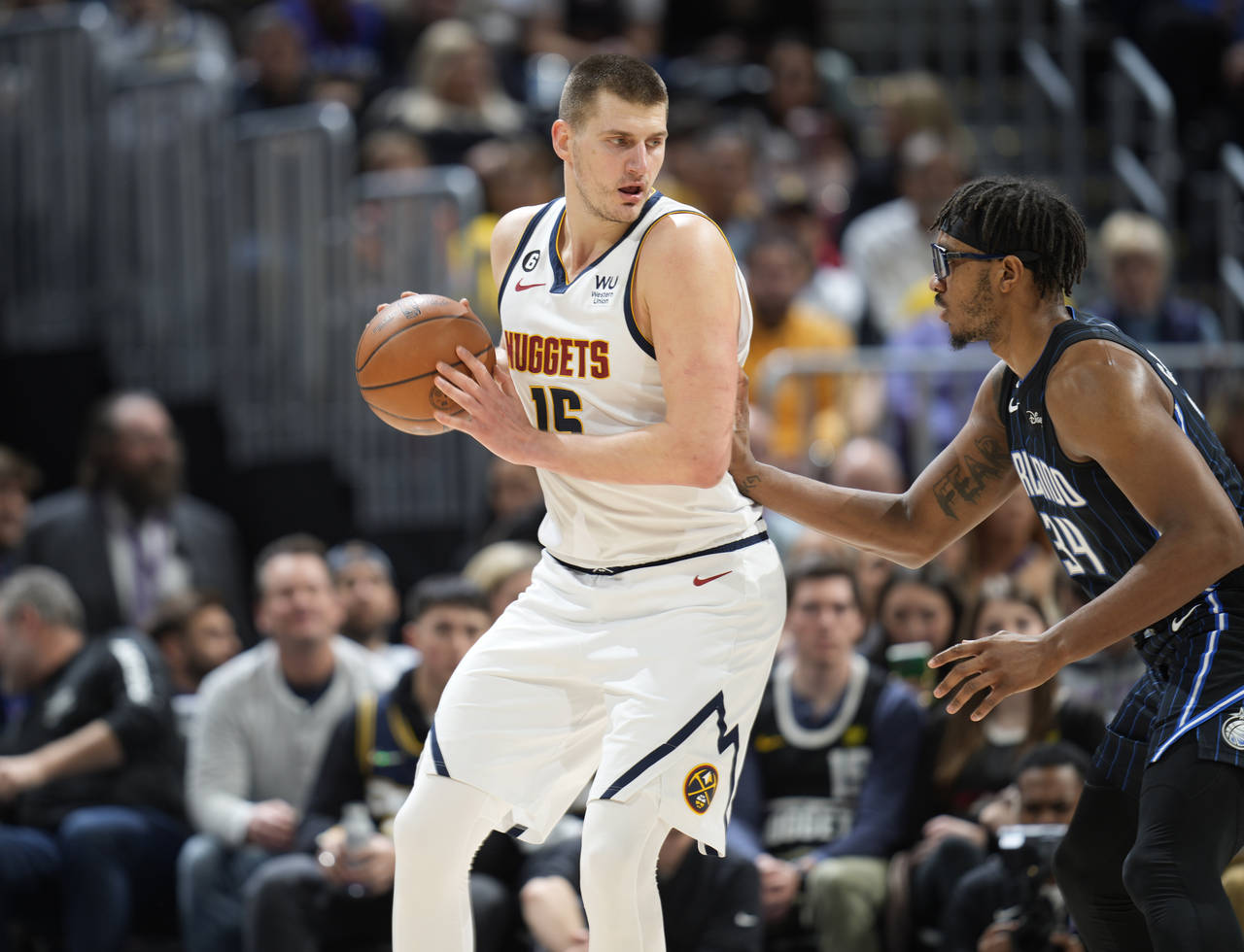Denver Nuggets center Nikola Jokic, left, looks to drive to the basket as Orlando Magic center Wend...