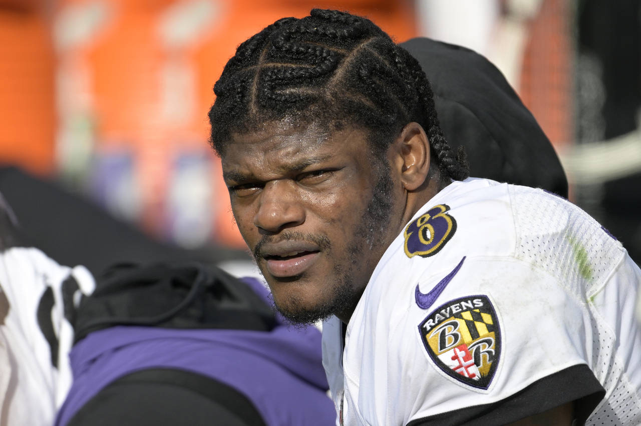 FILE - Baltimore Ravens quarterback Lamar Jackson (8) watches from the sideline during the first ha...