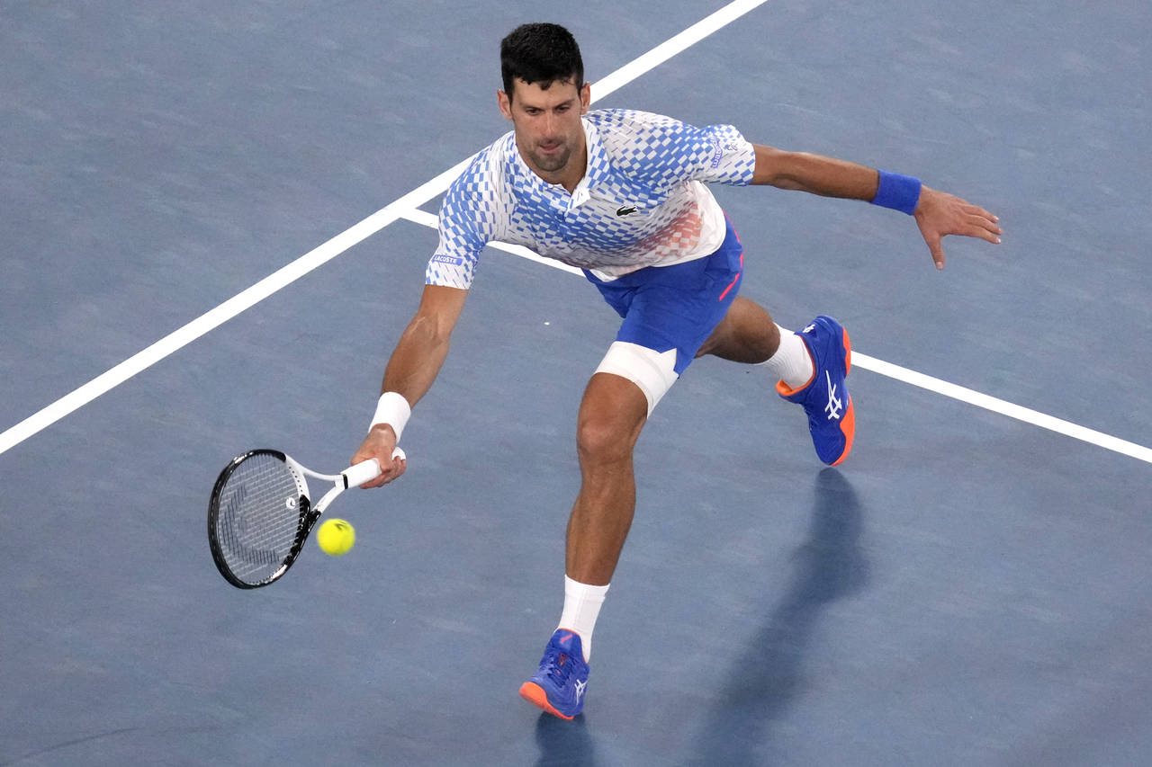Novak Djokovic of Serbia plays a forehand return to Alex de Minaur of Australia during their fourth...