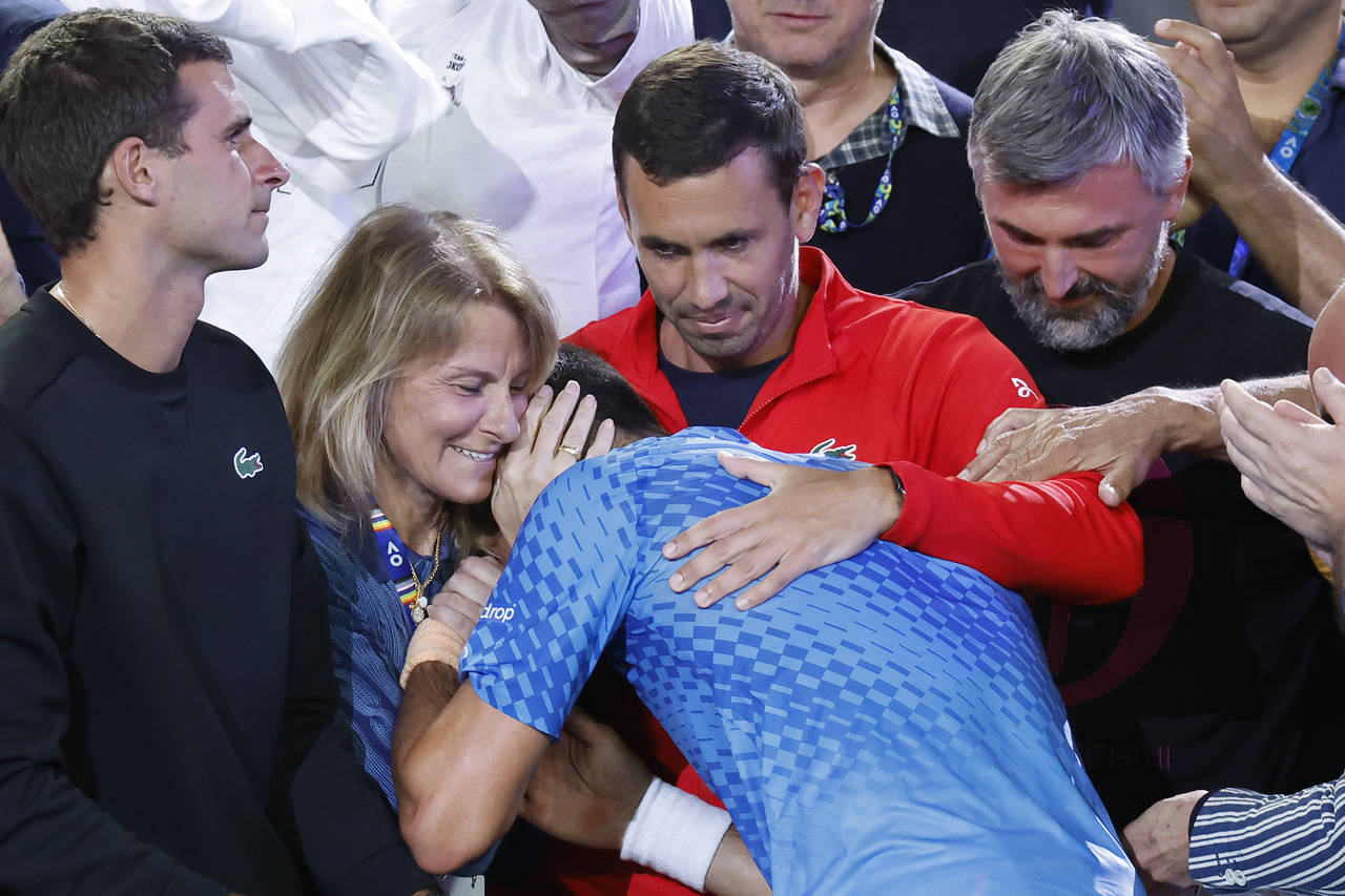 Novak Djokovic of Serbia, center, celebrates with his team including his mother, Dijana, second lef...