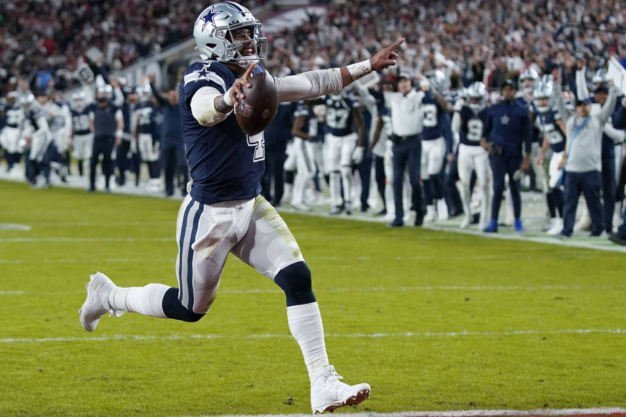 Dallas Cowboys quarterback Dak Prescott (4) runs into the end zone on a touchdown carry during the ...