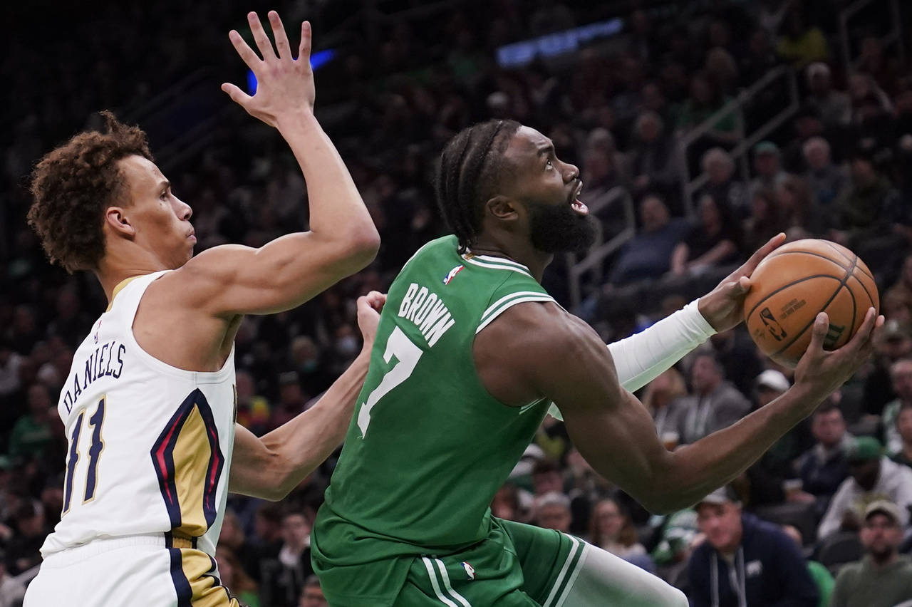 Boston Celtics guard Jaylen Brown (7) drives to the basket past New Orleans Pelicans guard Dyson Da...