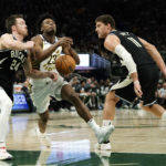 Holiday sparks late rally as Bucks beat Pacers 132-119