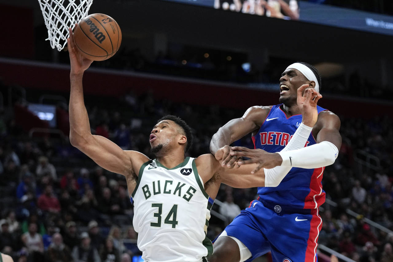 Milwaukee Bucks forward Giannis Antetokounmpo (34) is fouled by Detroit Pistons center Jalen Duren ...