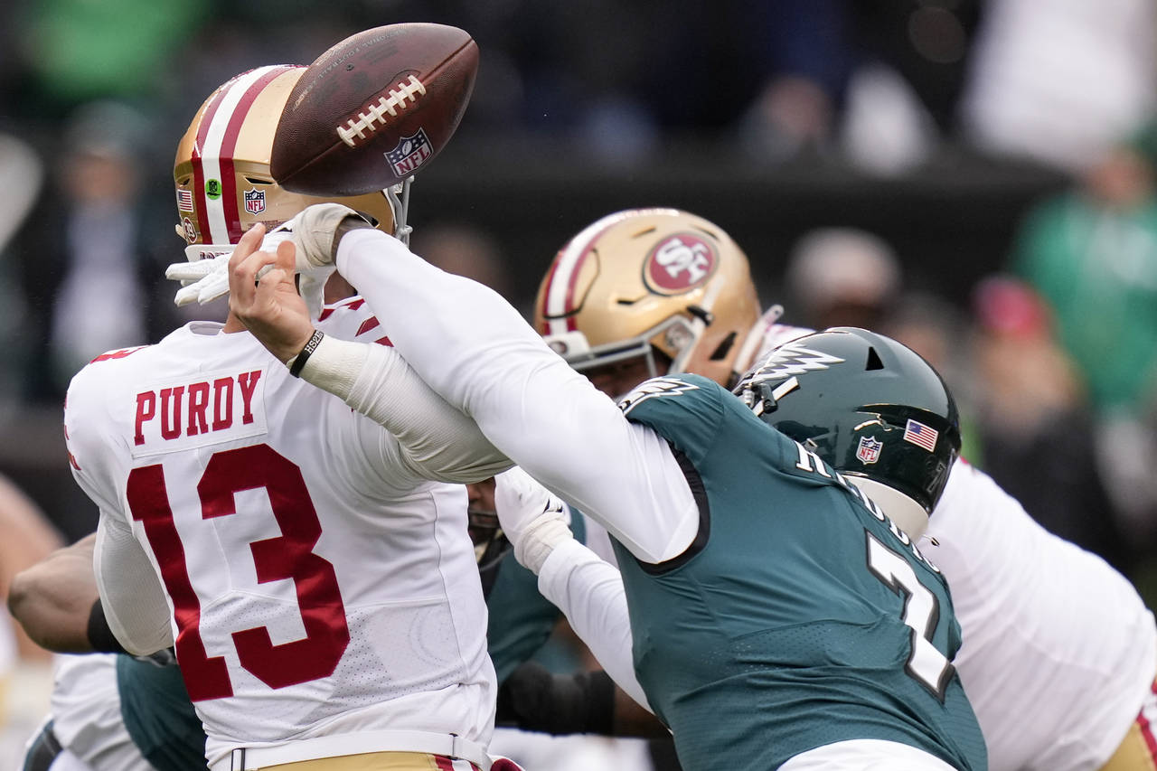 Philadelphia Eagles linebacker Haason Reddick, right, causes a fumble by San Francisco 49ers quarte...