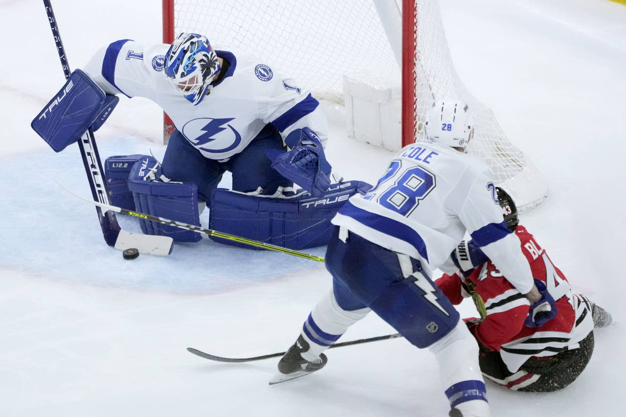 Tampa Bay Lightning goaltender Brian Elliott makes a save on a shot by Chicago Blackhawks' Colin Bl...