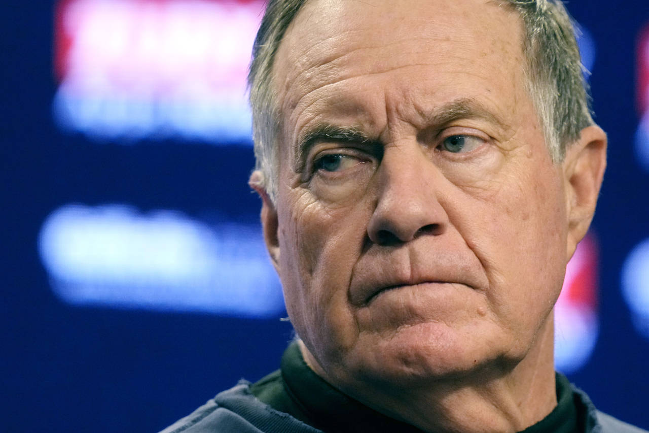 New England Patriots head coach Bill Belichick listens to a reporter's question during an availabil...