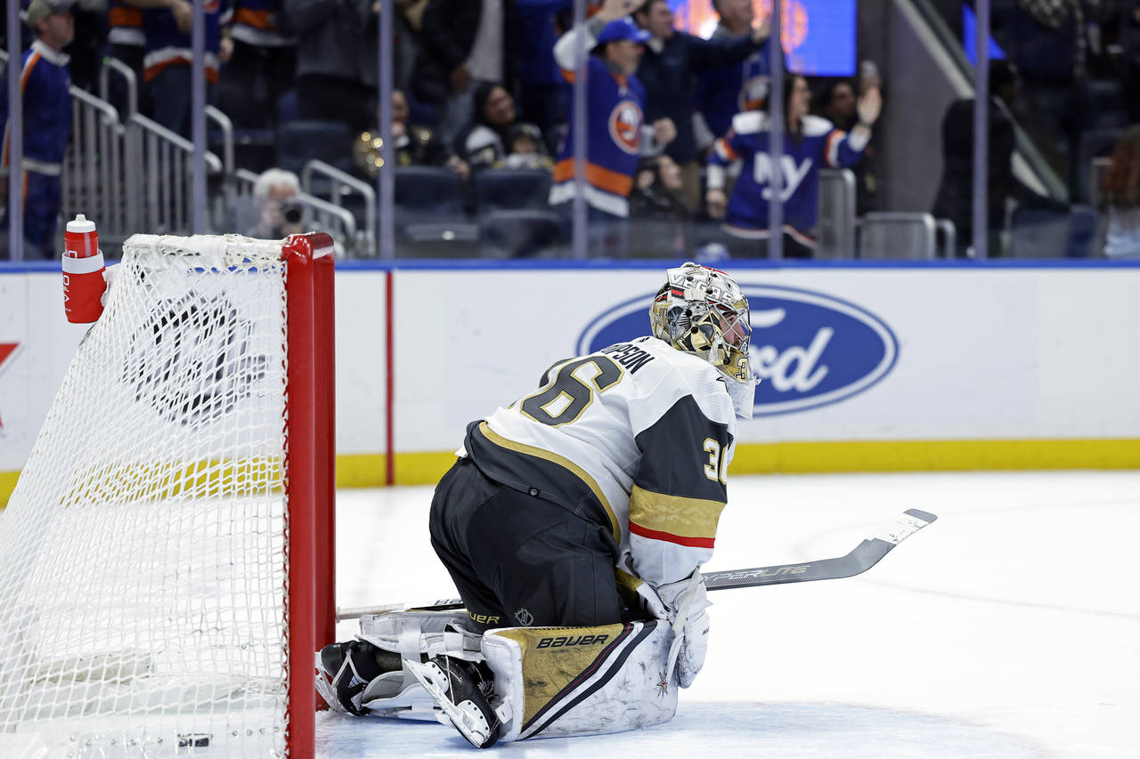 Vegas Golden Knights goaltender Logan Thompson reacts after giving up a goal to New York Islanders ...