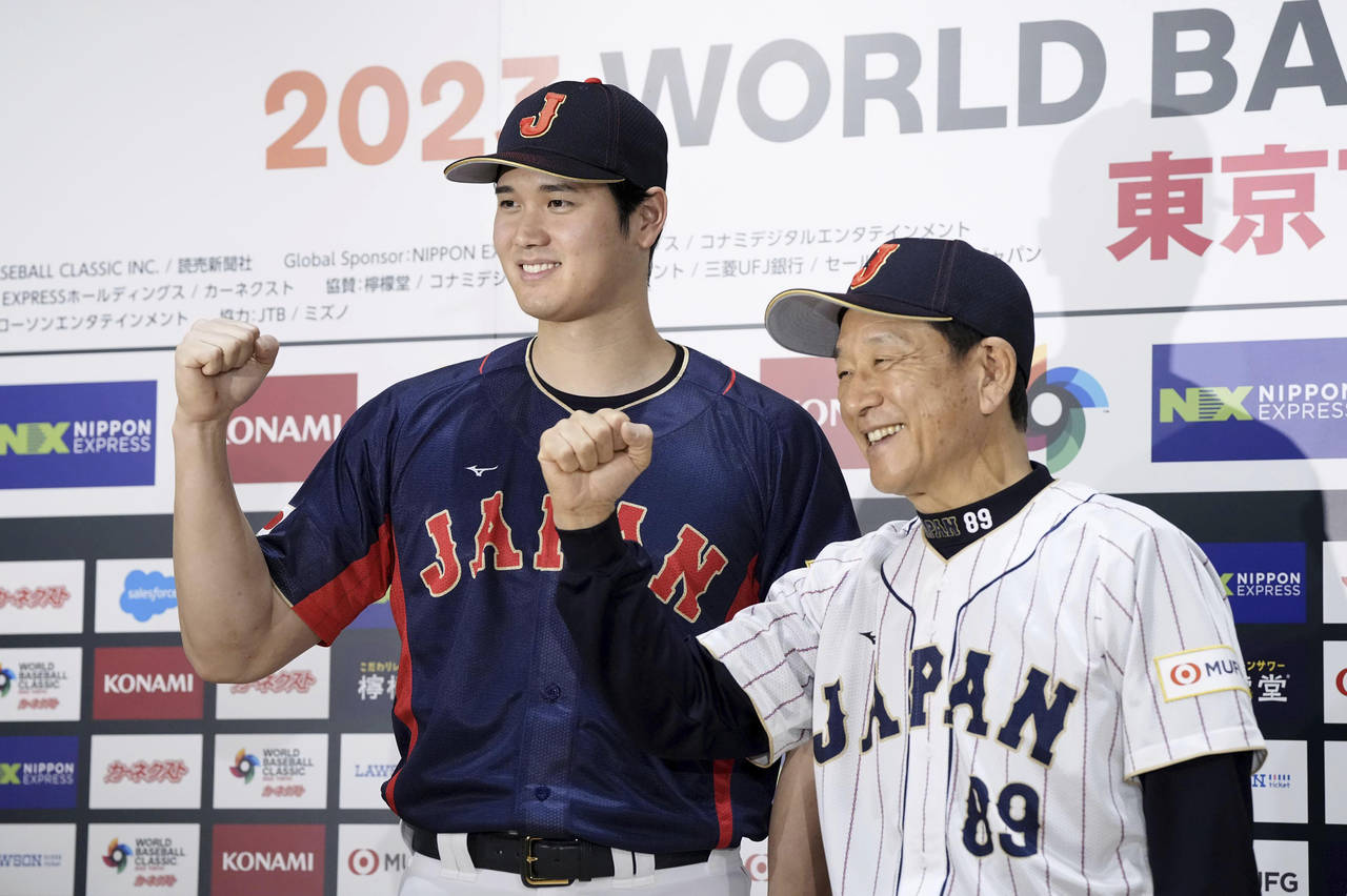 Shohei Ohtani, left, of Los Angeles Angels, and Japan's manager Hideki Kuriyama, right, pose togeth...