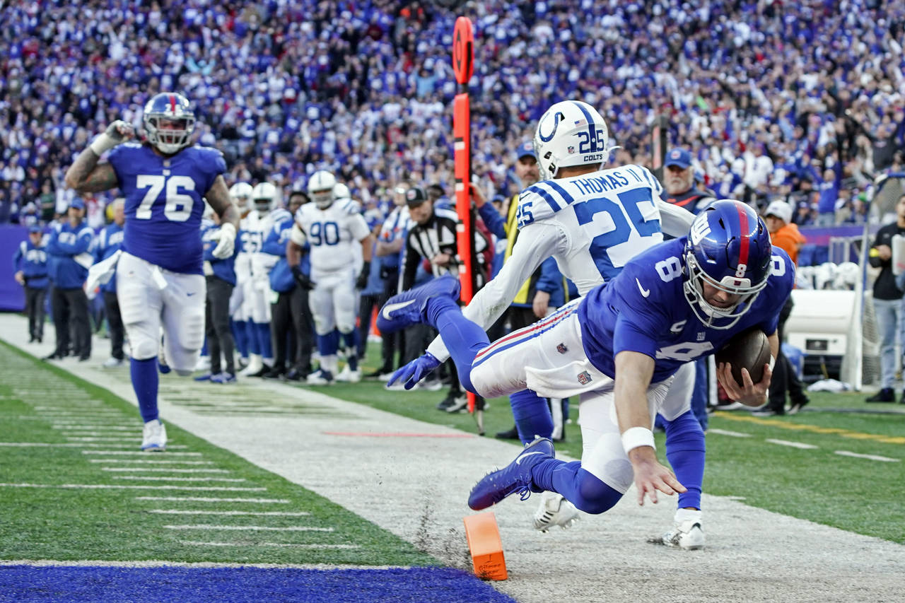 New York Giants' Daniel Jones (8) dives past Indianapolis Colts' Rodney Thomas II (25) for a touchd...