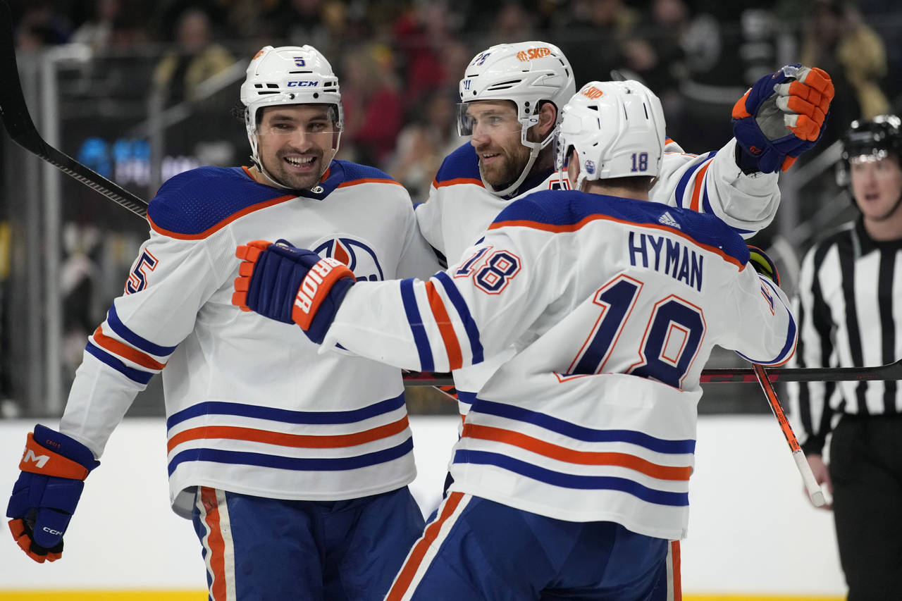 Edmonton Oilers center Leon Draisaitl, center, celebrates after scoring against the Vegas Golden Kn...
