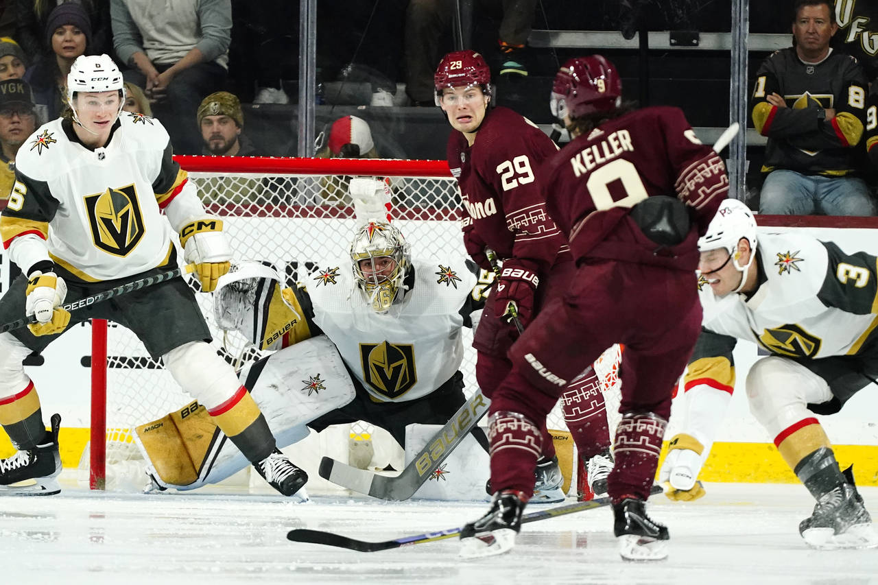 Arizona Coyotes right wing Clayton Keller (9) sends the puck past Vegas Golden Knights defenseman B...