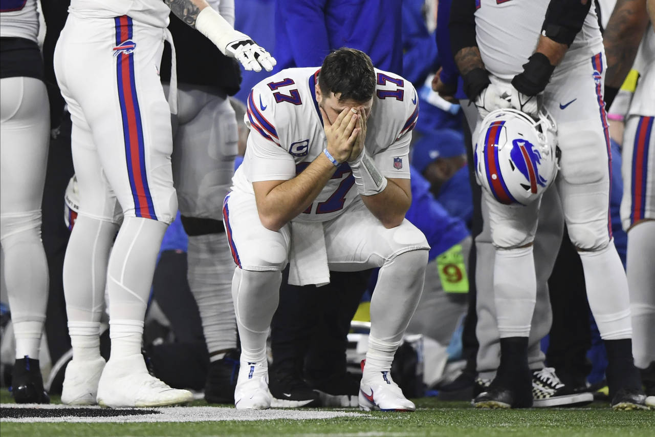 Buffalo Bills quarterback Josh Allen (17) pauses as Damar Hamlin is examined by medical staff durin...