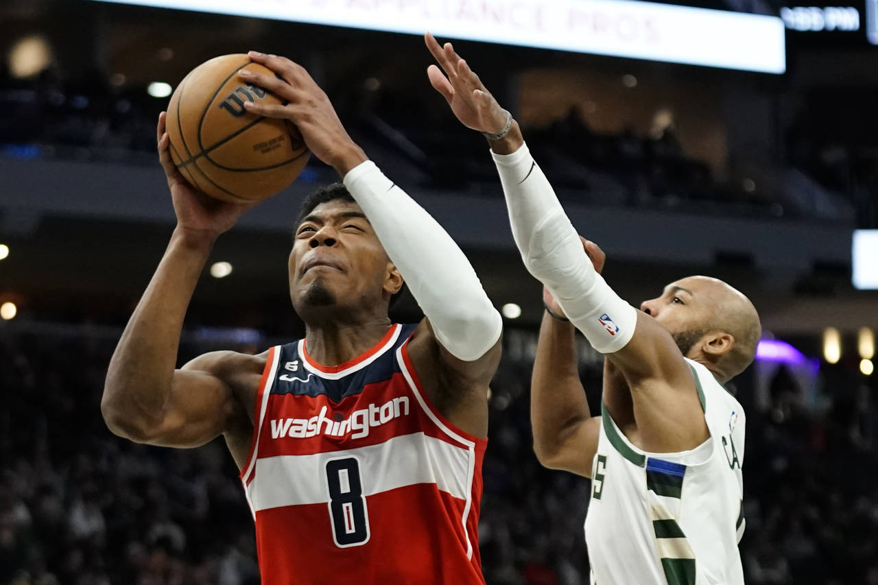 Washington Wizards' Rui Hachimura drives to the basket against Milwaukee Bucks' Jevon Carter during...