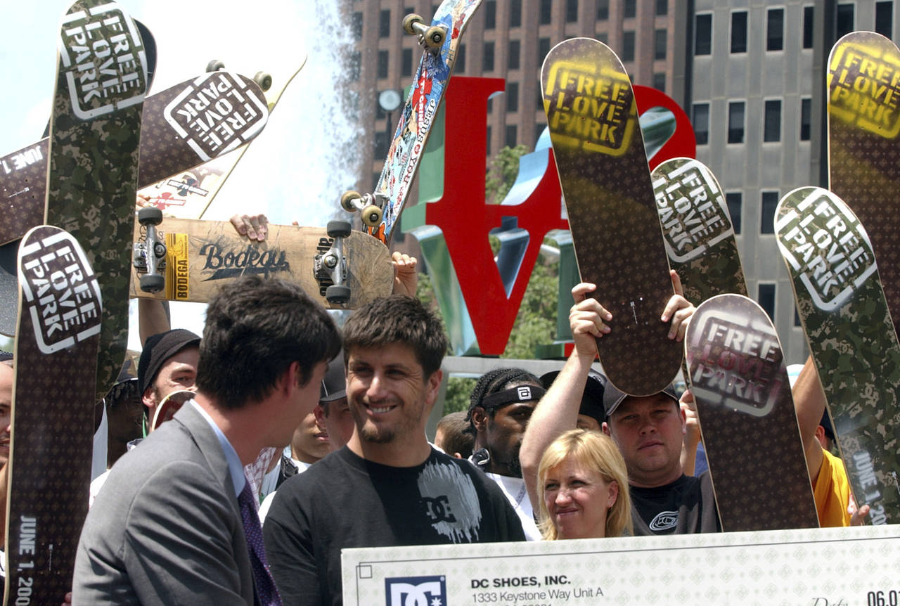 FILE - Skateboarders cheer as DC Shoes President Ken Block, center, wearing black shirt, smiles aft...