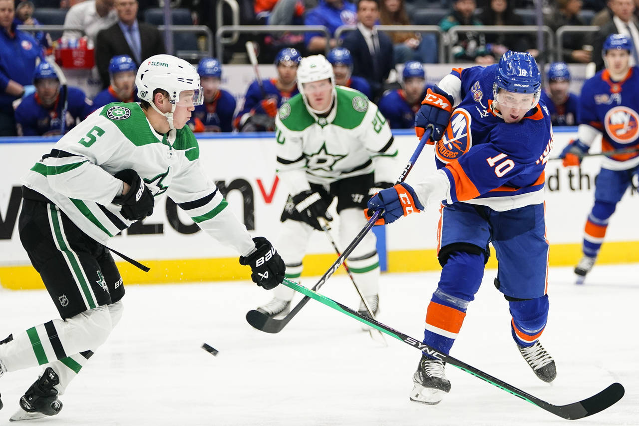 New York Islanders' Simon Holmstrom (10) shoots the puck past Dallas Stars' Nils Lundkvist (5) duri...