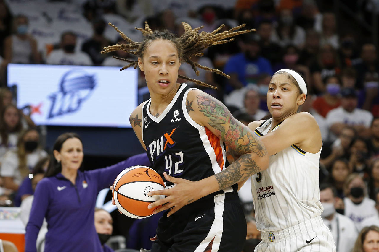 FILE - Phoenix Mercury center Brittney Griner (42) drives past Chicago Sky forward Candace Parker (...