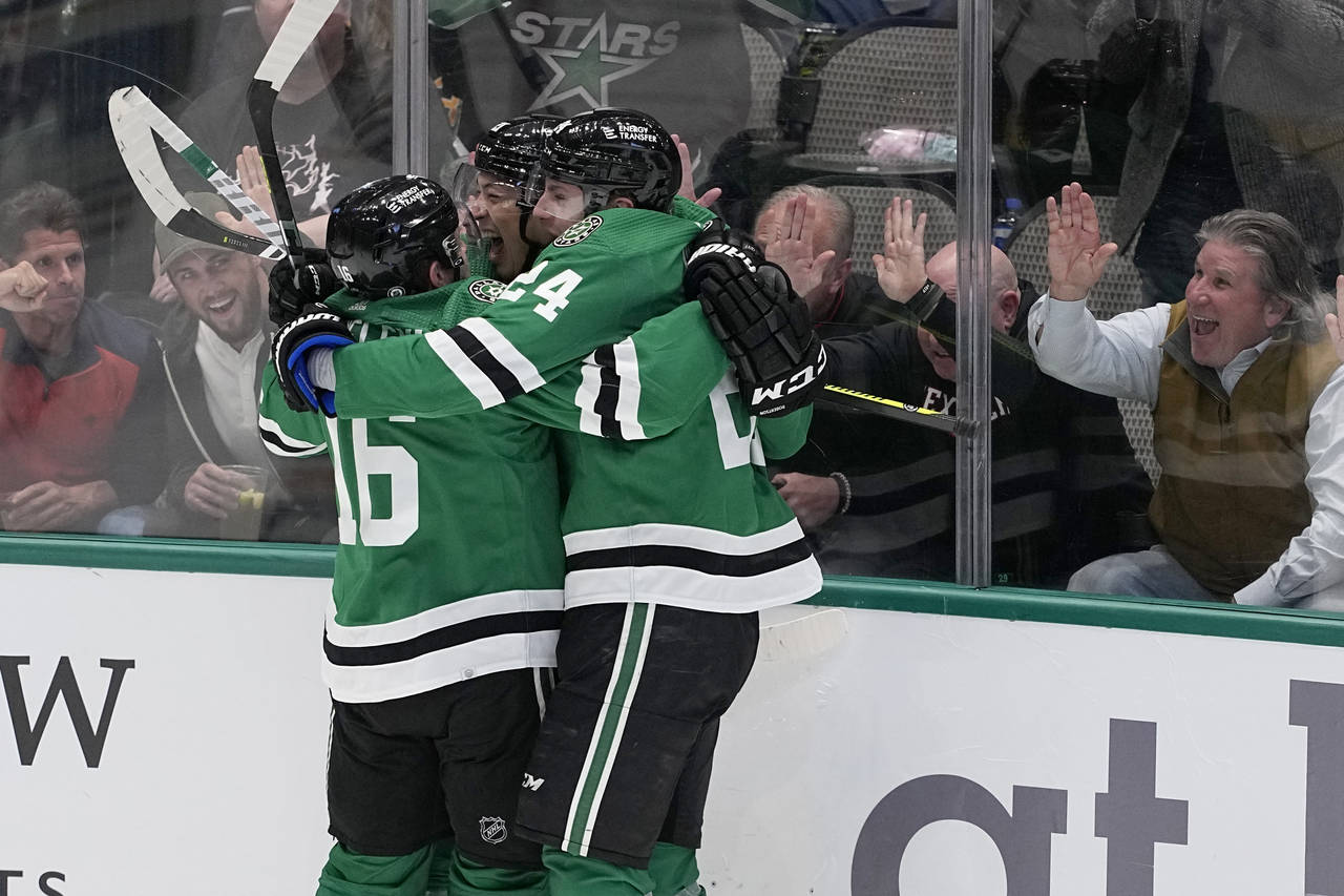 Dallas Stars' Joe Pavelski, left, Jason Robertson, center, and Roope Hintz, right, celebrate ater R...
