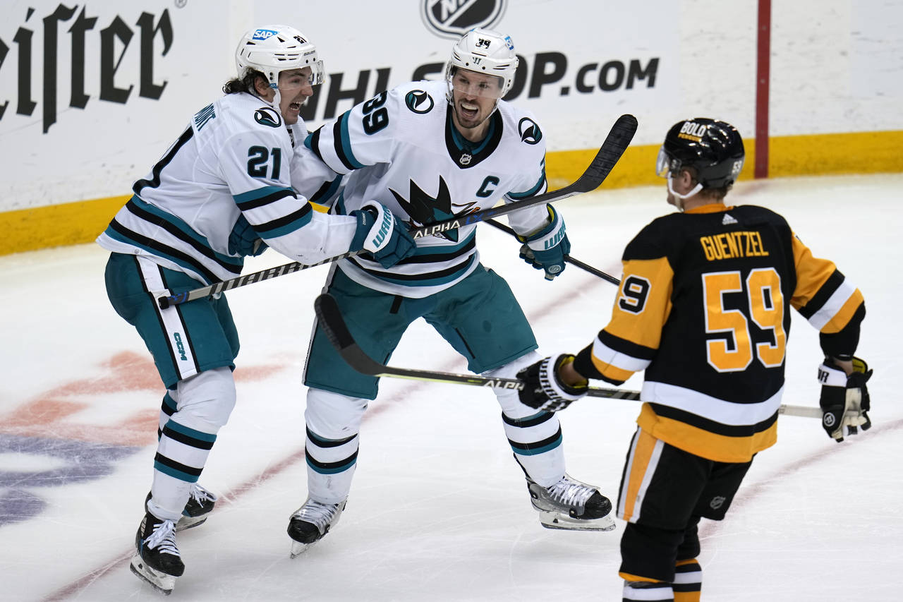 San Jose Sharks' Logan Couture (39) celebrates after his goal with Michael Eyssimont (21) during th...