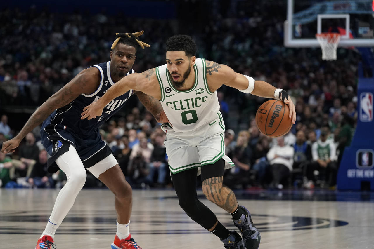 Boston Celtics forward Jayson Tatum drives against Dallas Mavericks forward Reggie Bullock (25) dur...