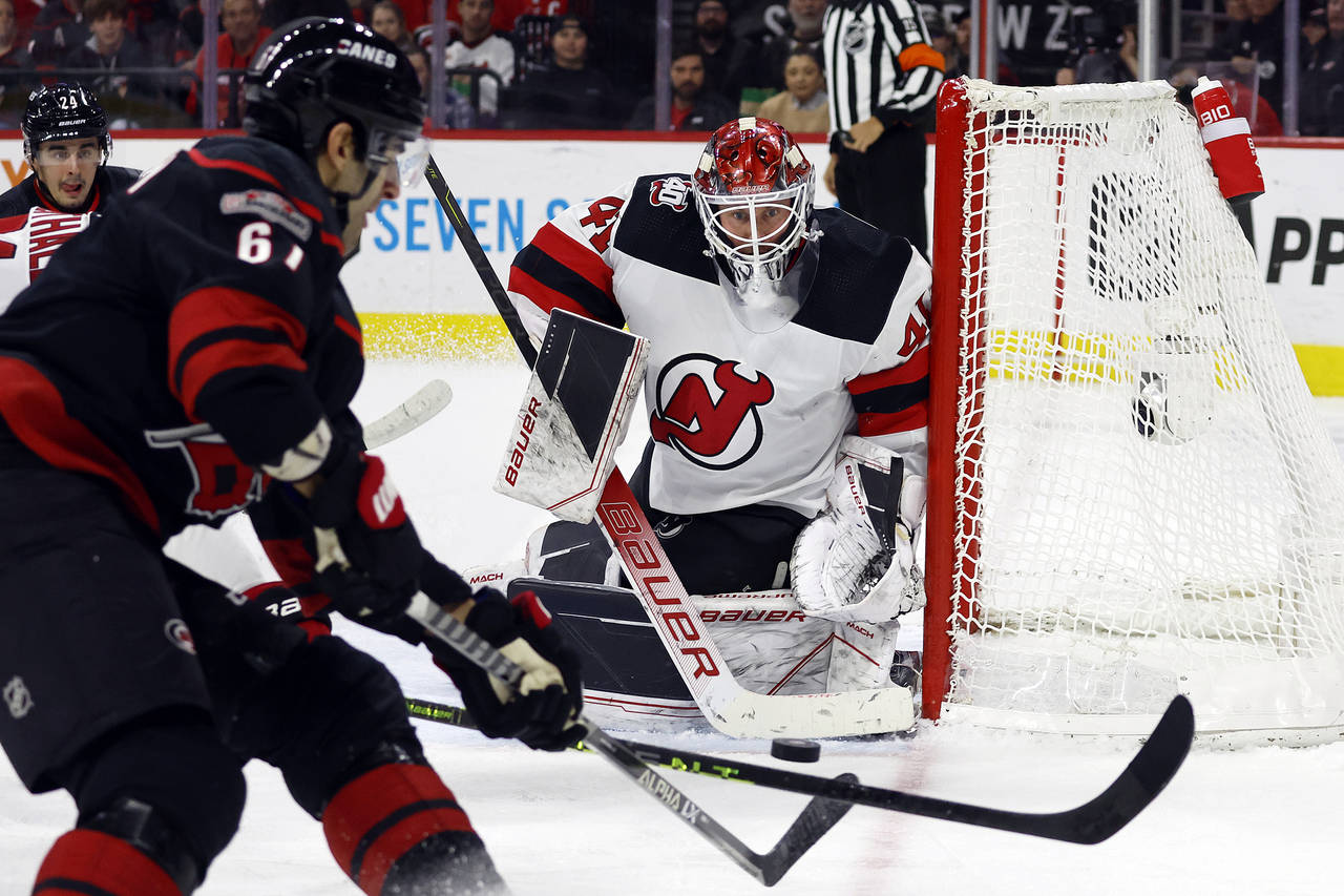 Carolina Hurricanes' Max Pacioretty (67) backhands the puck at New Jersey Devils goaltender Vitek V...