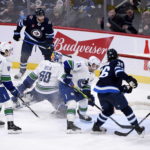 Connor's hat trick powers Jets' 7-4 win over Canucks
