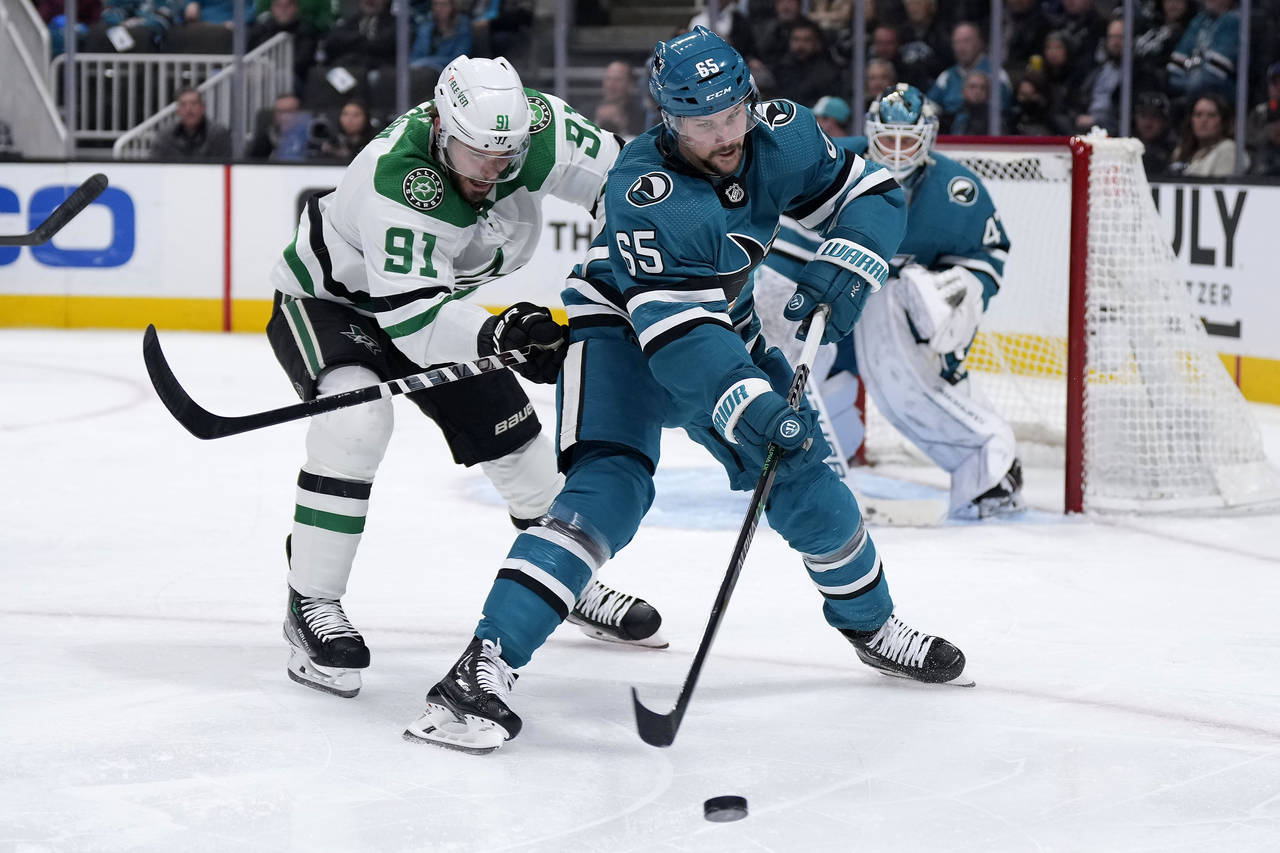 San Jose Sharks defenseman Erik Karlsson (65) works for the puck against Dallas Stars center Tyler ...