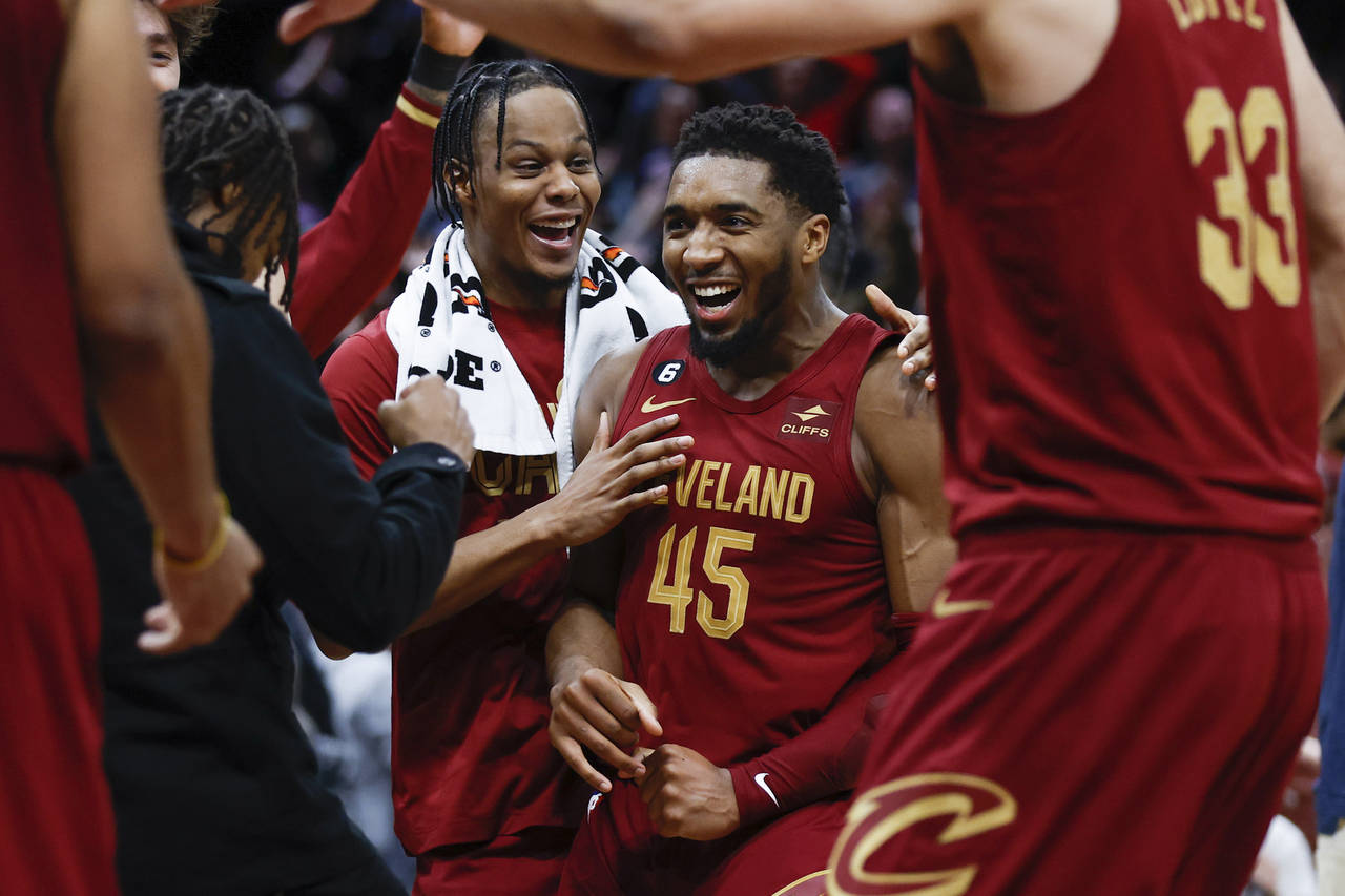 Cleveland Cavaliers guard Donovan Mitchell (45) celebrates with teammates after making a basket to ...