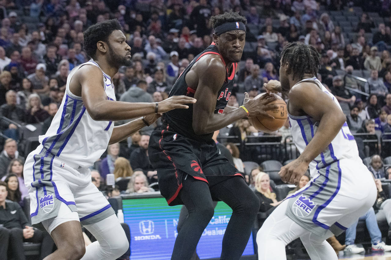 Sacramento Kings forward Chimezie Metu, left, and Sacramento Kings guard Davion Mitchell guard Toro...