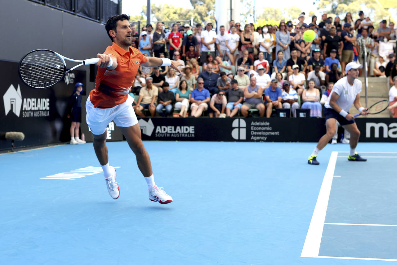 Serbia's Novak Djokovic and Canada's Vasek Pospisil plays a return shot during their doubles match ...