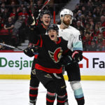 
              Ottawa Senators left wing Tim Stutzle (18) celebrates after his goal with left wing Brady Tkachuk (7) as Seattle Kraken defenseman Adam Larsson (6) skates away during second-period NHL hockey game action in Ottawa, Ontario, Saturday, Jan. 7, 2023. (Justin Tang/The Canadian Press via AP)
            