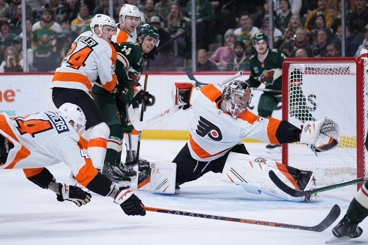 Philadelphia Flyers goaltender Carter Hart (79), front right, blocks a shot during the third period...