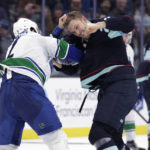 
              Seattle Kraken defenseman Jamie Oleksiak, right, fights with Vancouver Canucks defenseman Luke Schenn (2) during the second period of an NHL hockey game Wednesday, Jan. 25, 2023, in Seattle. (AP Photo/John Froschauer)
            